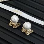 Gold filigree butterfly earrings with large white pearl studs