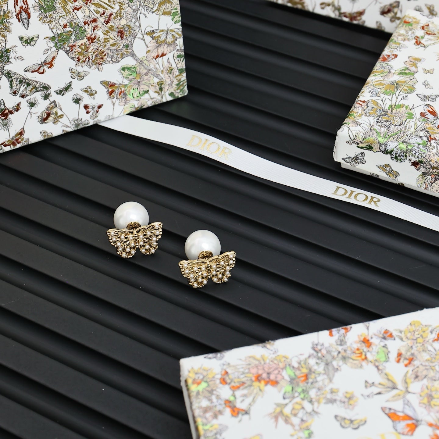 Gold butterfly earrings with white pearl studs and crystal accents