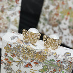 Gold butterfly earrings with white pearls and detailed crystal embellishment