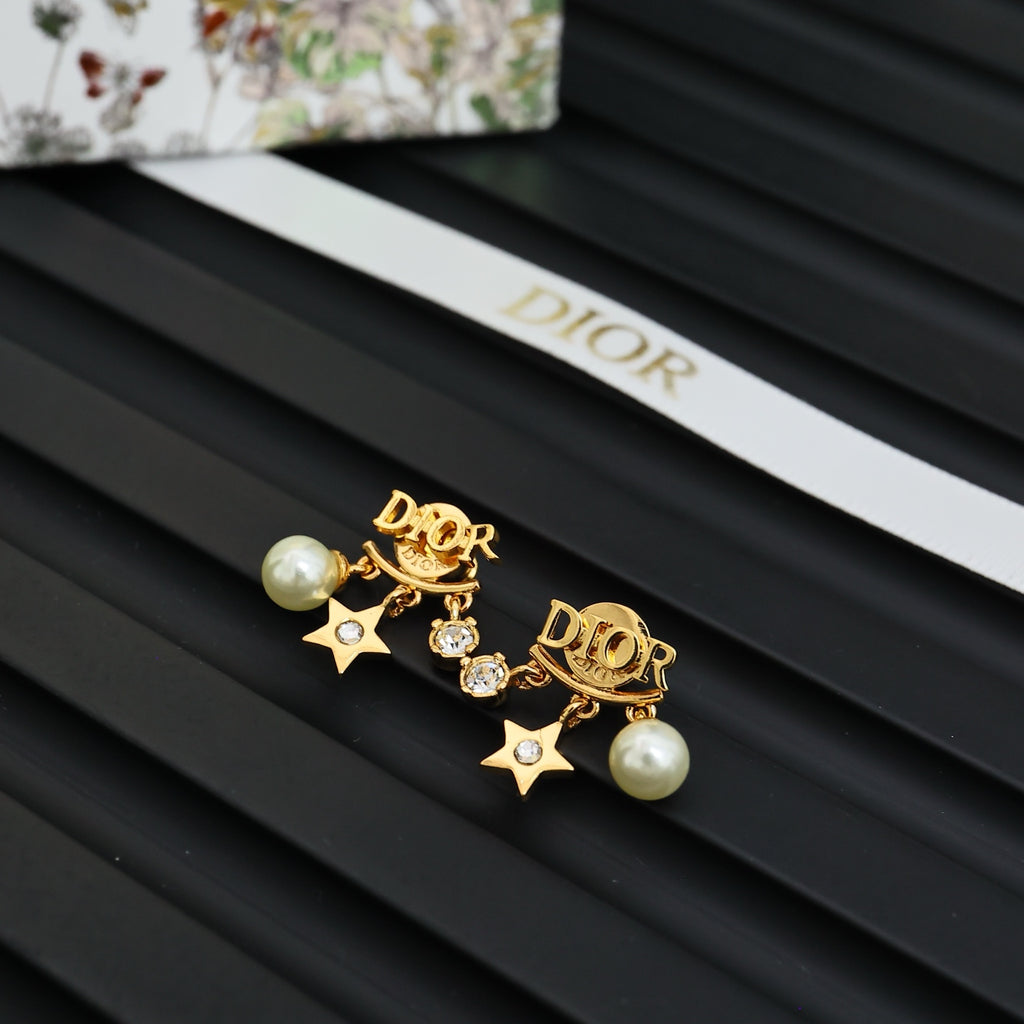 Dior gold-tone drop earrings with pearl, star, and rhinestone accents