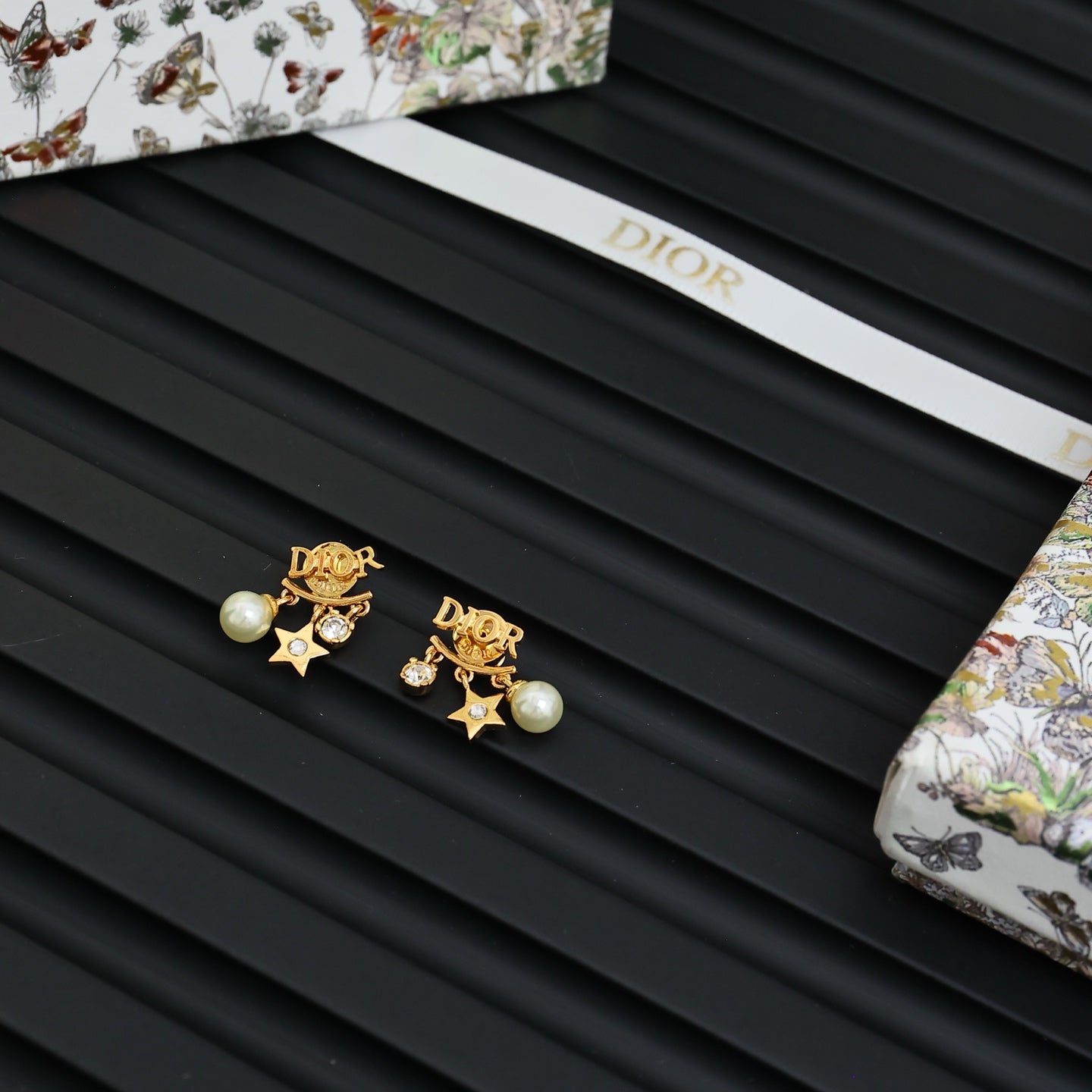 Dior gold-tone star and pearl earrings with rhinestone logo accents