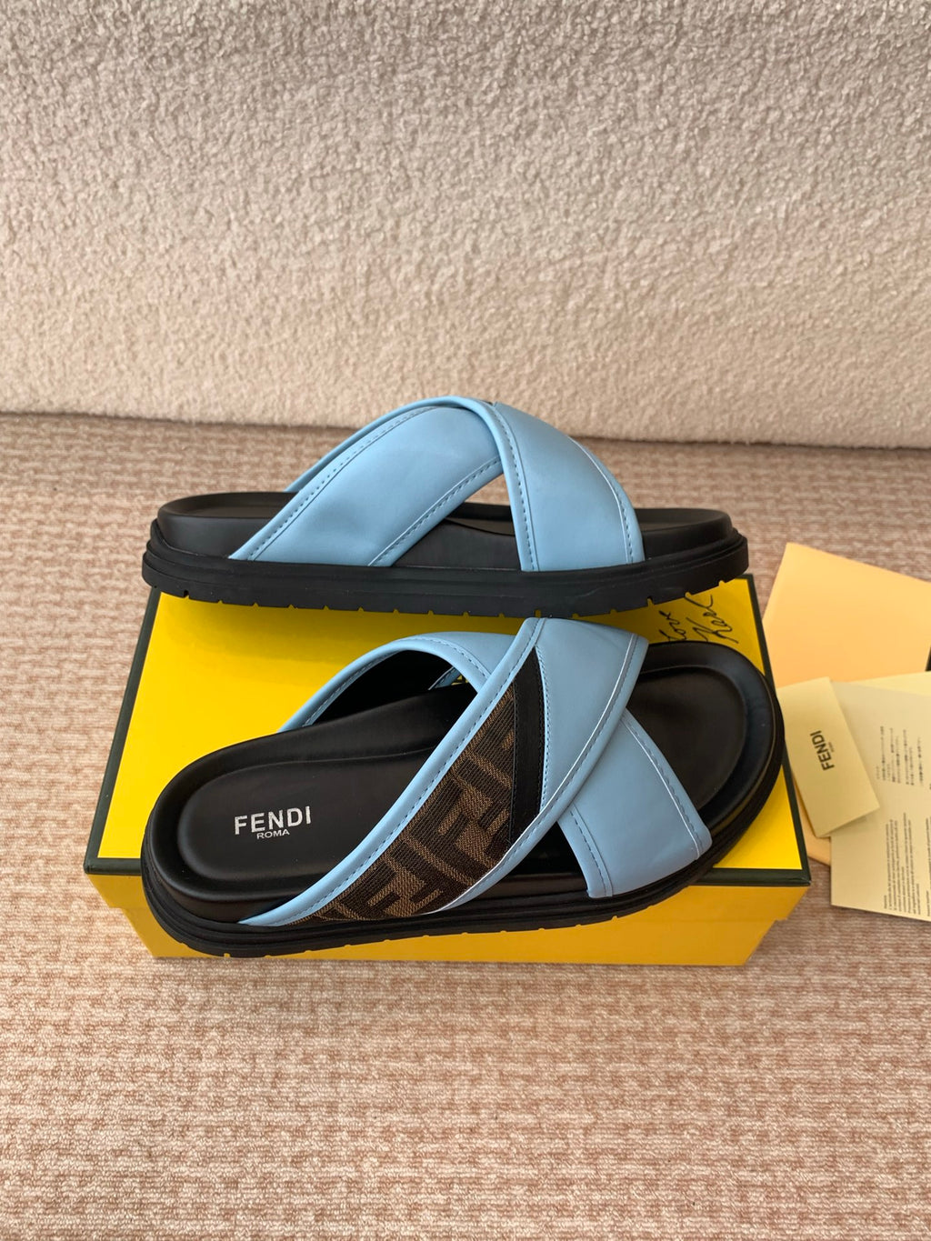Light blue slide sandals with double straps and black ridged sole