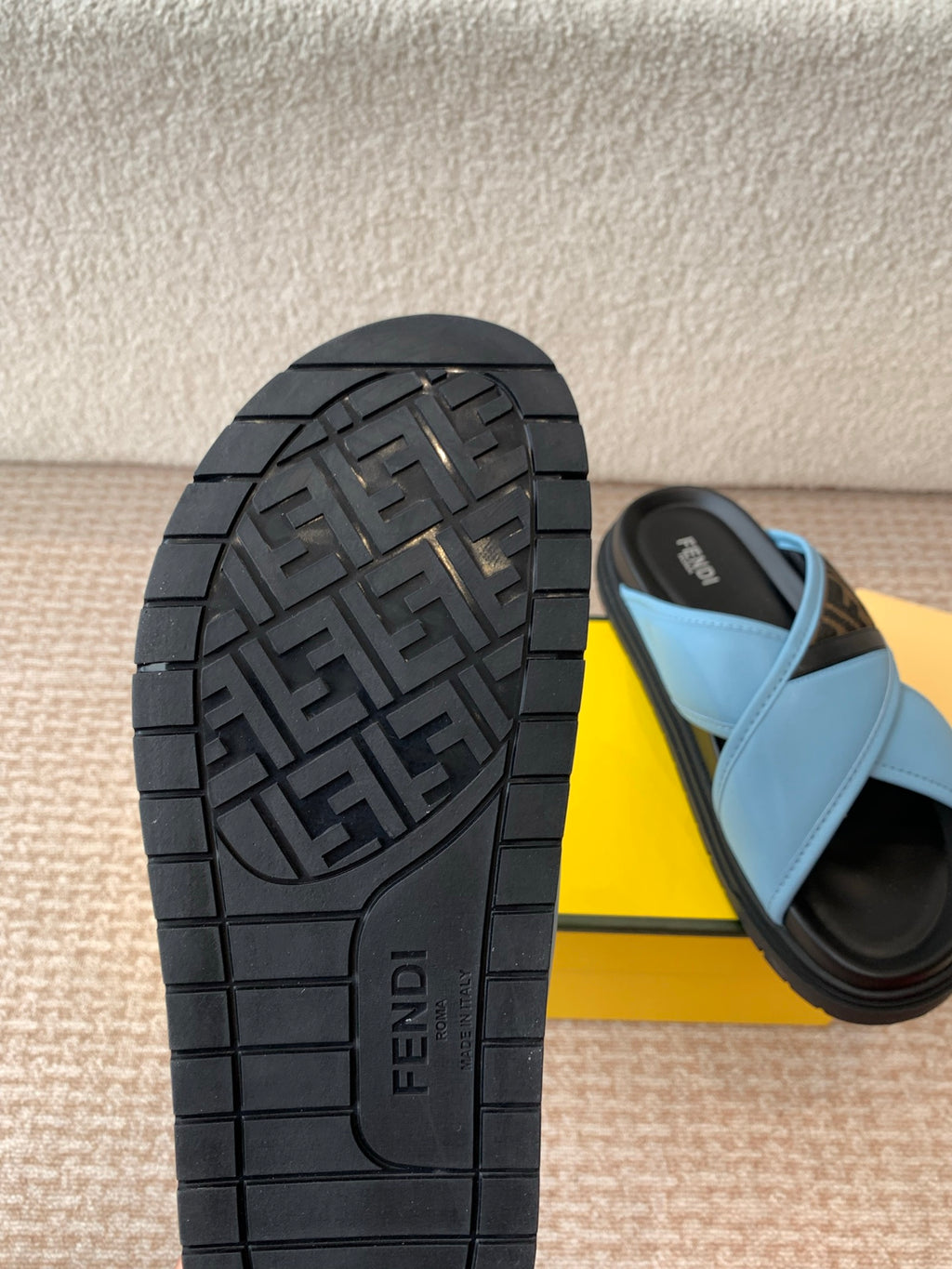 Black rubber outsole with Fendi logo tread pattern and light blue strap
