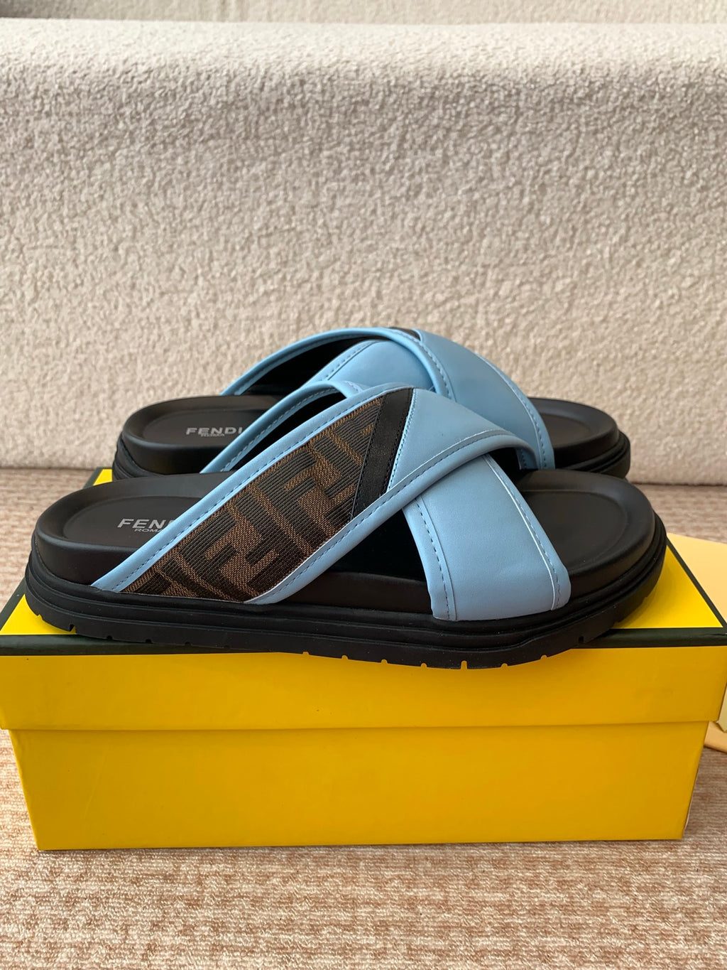 Light blue slide sandals with cross strap over dark printed footbed