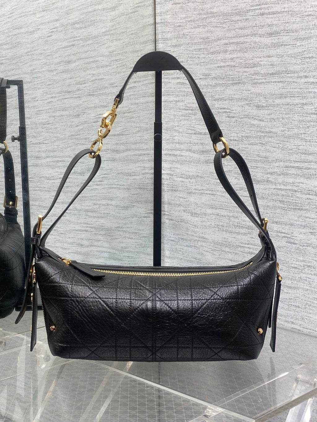Black Dior quilted shoulder bag with gold-tone chain straps and zipper top