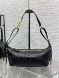 Black Dior quilted shoulder bag with gold-tone chain straps and zipper top