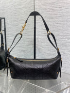Black Dior quilted shoulder bag with gold-tone chain straps and zipper top