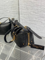Black Dior small satchel with gold zipper, chain strap, and logo charm