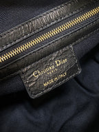 Black Dior leather bag with gold zipper and 'Made in Italy' logo patch