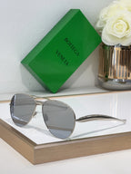 Bottega Veneta sunglasses with silver metal frame and light gray lenses