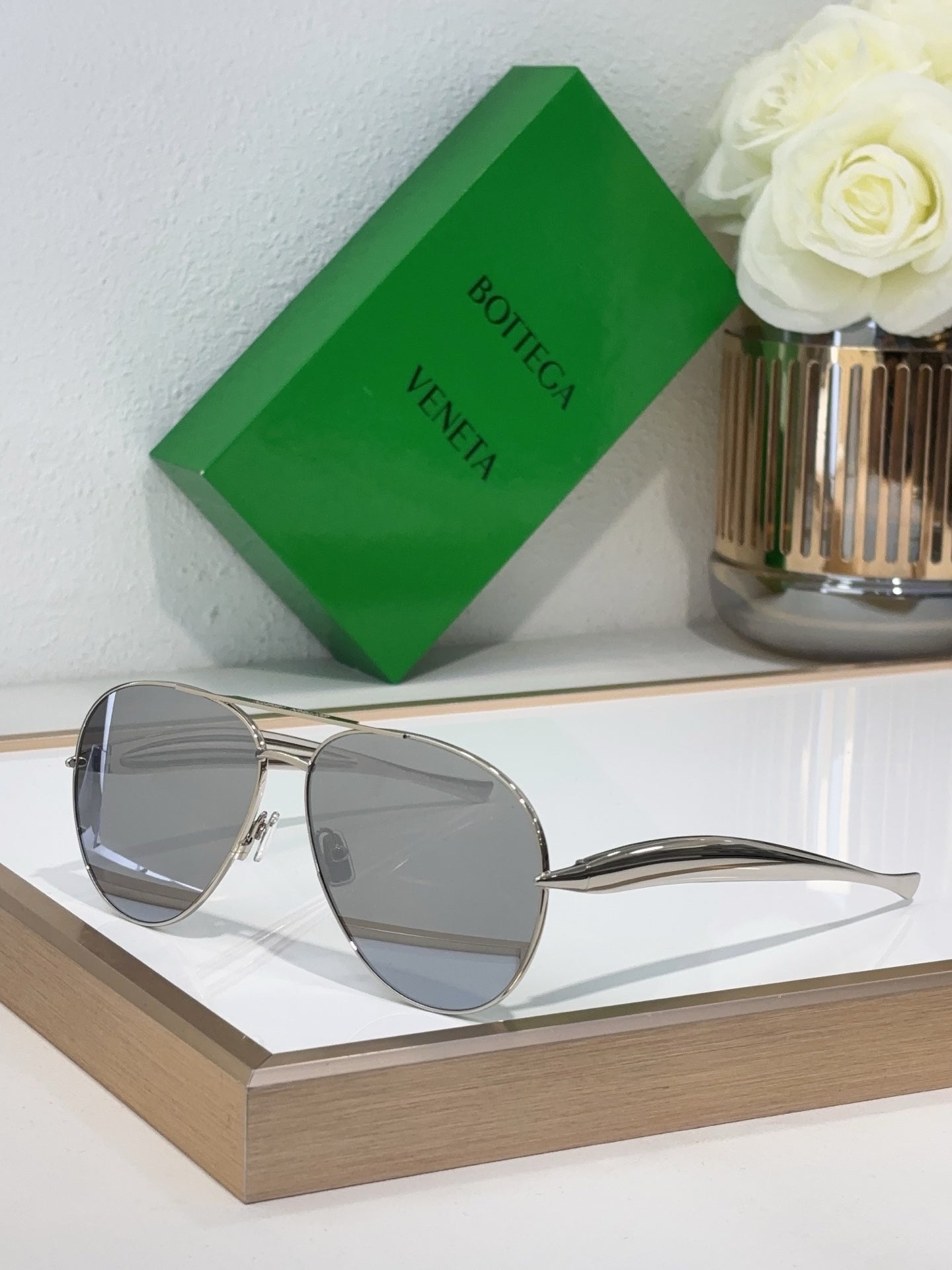 Bottega Veneta sunglasses with silver metal frame and light gray lenses