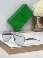 Bottega Veneta sunglasses with silver metal frame and gray lenses