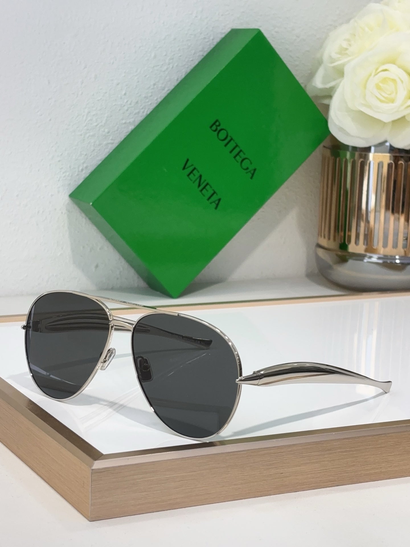 Bottega Veneta sunglasses with silver metal frame and dark gray lenses