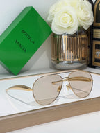 Bottega Veneta sunglasses with gold metal frame and clear lenses