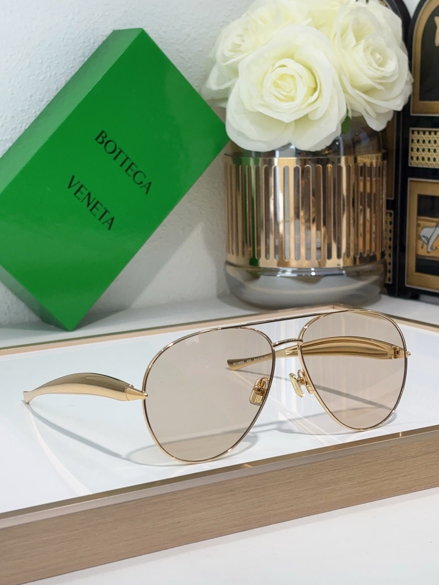 Bottega Veneta sunglasses with gold metal frame and clear lenses