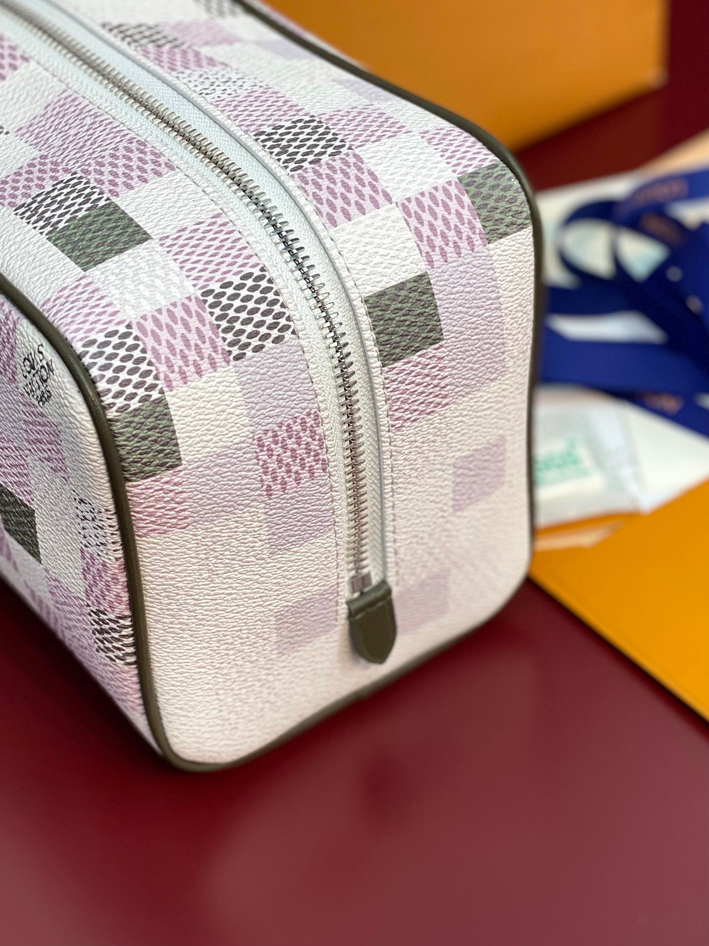 Louis Vuitton crossbody bag front close-up, multicolor check pattern with zipper