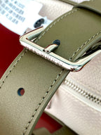 Louis Vuitton crossbody bag hardware close-up, green strap with metal buckle detail