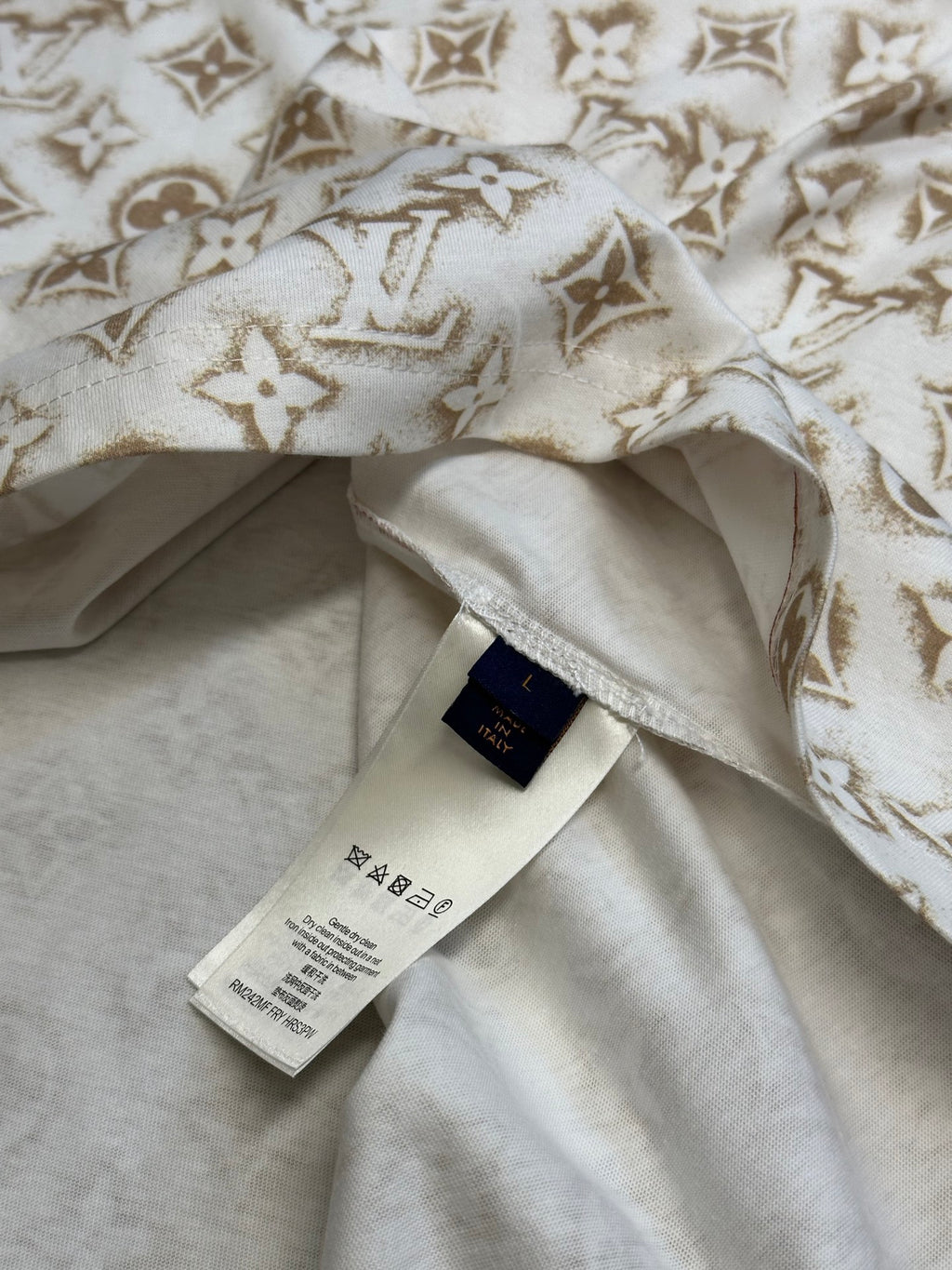Cream T-shirt with gold monogram fabric, inner label and stitched neckline.
