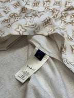 Cream T-shirt with gold monogram fabric, inner label and stitched neckline.