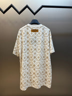 Cream short-sleeve T-shirt with gold monogram pattern, back view.