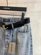 Light blue denim pants with black leather belt and button fly