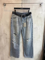 Light blue distressed denim pants with belt loops and ripped knees