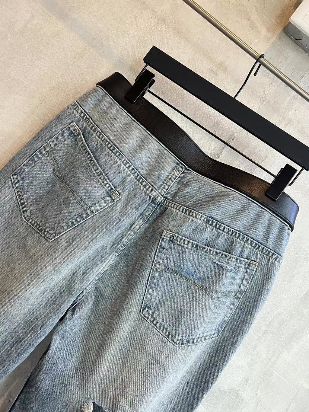 Light blue denim pants with patch pocket detail and stitched seams