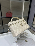 Mini quilted white Chanel bag with top handle, zipper, and chain strap