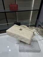 Quilted white Chanel crossbody bag with chain strap and top zipper