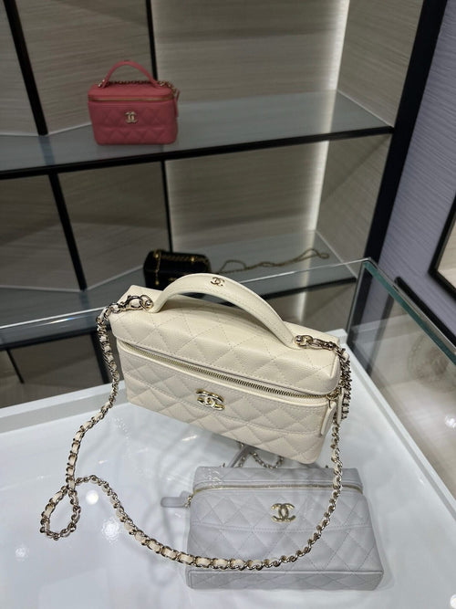 Quilted white Chanel shoulder bag with chain strap and top zipper