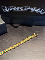 Gold-tone tennis bracelet with repeating teal-green stone clusters