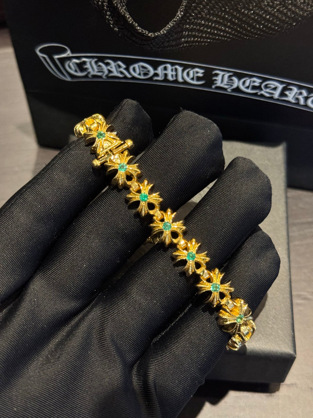 Gold-tone gemstone bracelet with starburst settings and teal stones