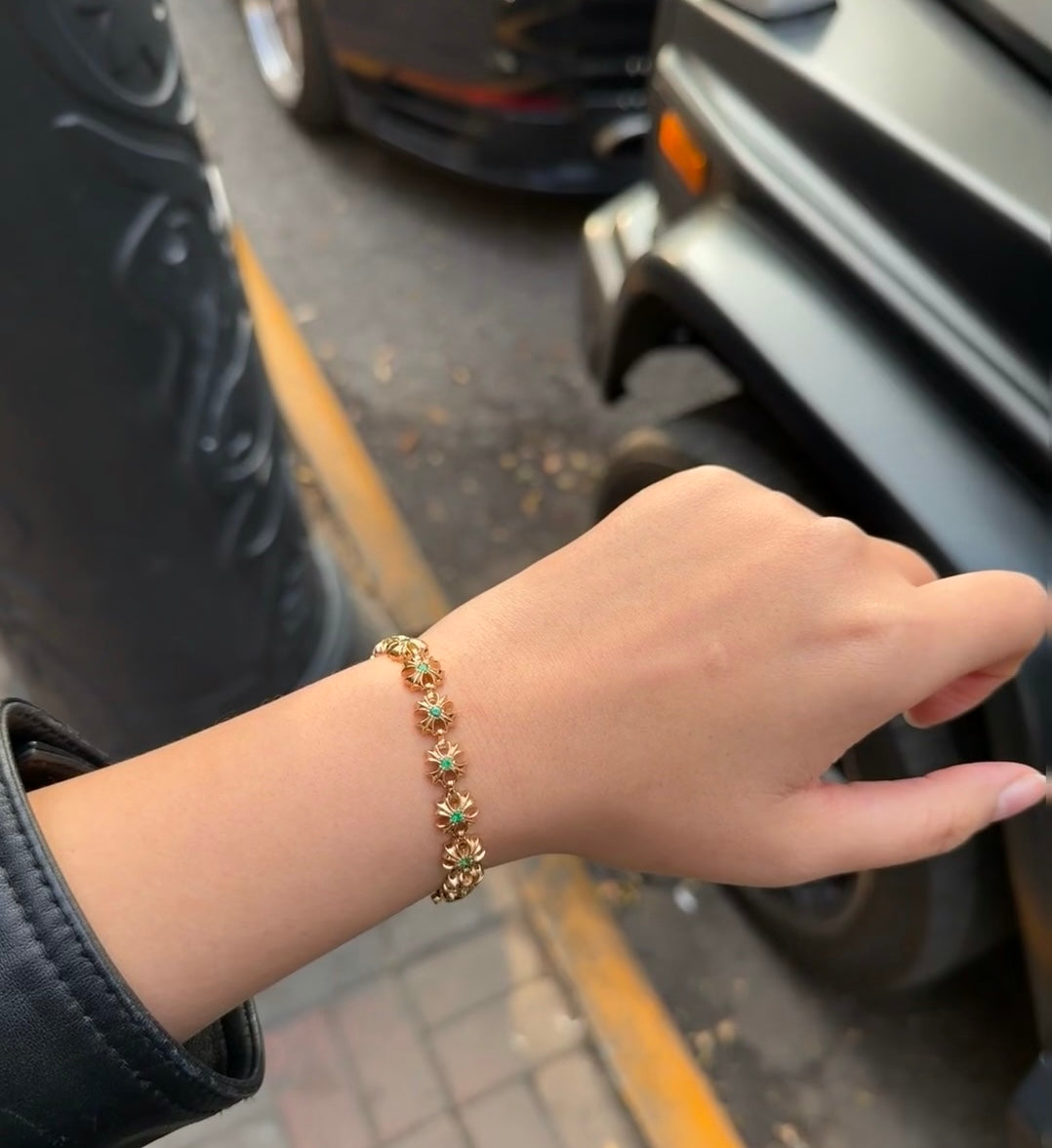 Gold-tone teal-stone link bracelet on wrist