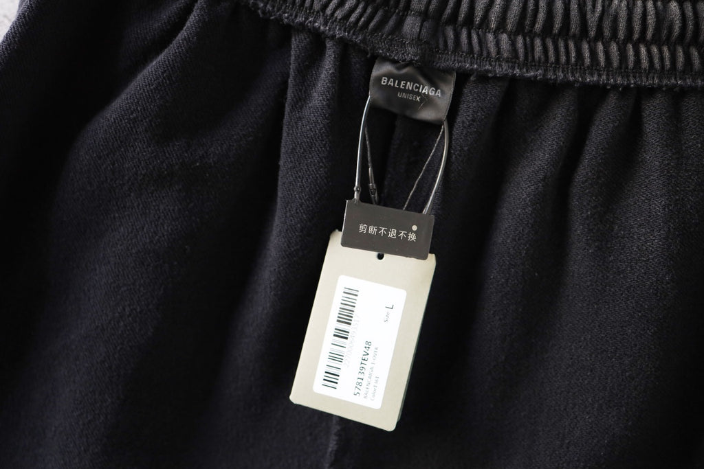 Dark gray shorts with Balenciaga hangtag attached at the waistband