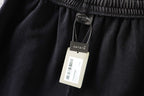 Dark gray shorts with Balenciaga hangtag attached at the waistband