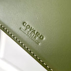 Goyard logo embossed on green leather trim with contrast stitching