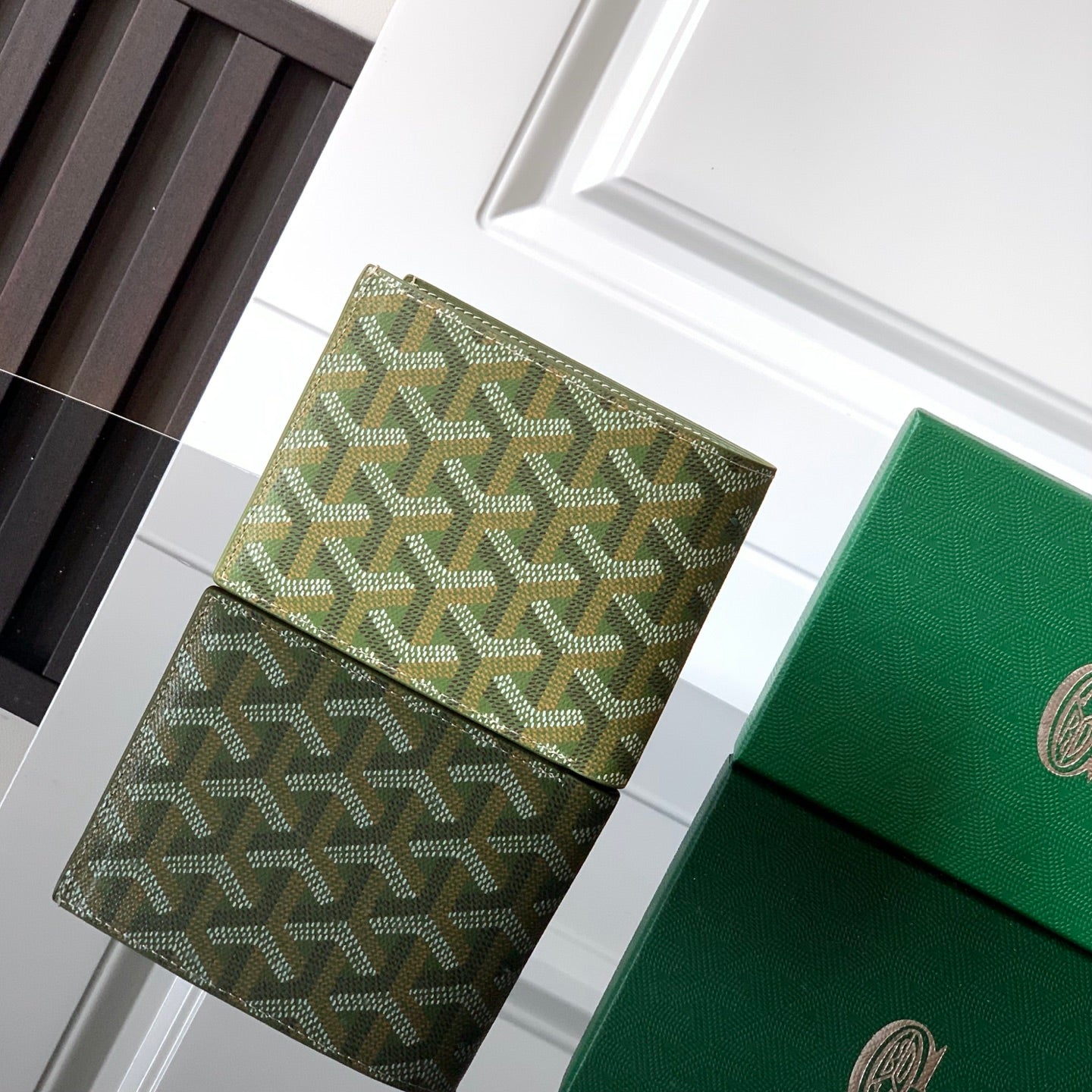 Goyard wallet with green geometric pattern and snap flap