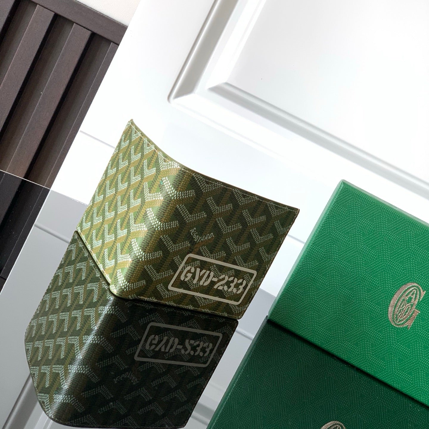 Goyard wallet with green patterned flap and embossed logo panel