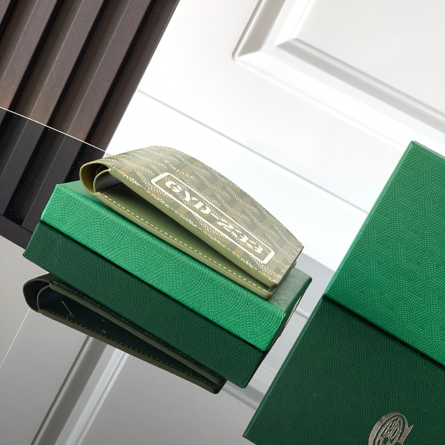 Green Goyard small bag with monogram flap and fold-over strap