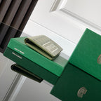 Green leather card holder with stitched trim and hanging loop