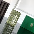 Goyard-pattern card holder with green leather, logo patch and snap closure