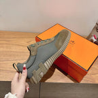 Unisex sneakers shoe on box, blue-gray upper with suede toe and teal laces