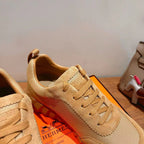 Hermes unisex beige lace-up sneakers, close-up of lace-up panel and heel collar