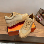 Hermes unisex beige lace-up sneakers, front view with ridged rubber sole
