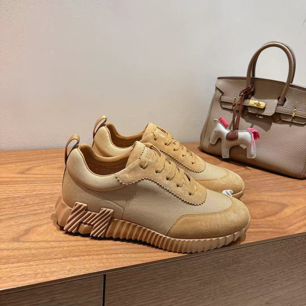 Hermes unisex beige lace-up sneakers, angled side profile with sculpted sole