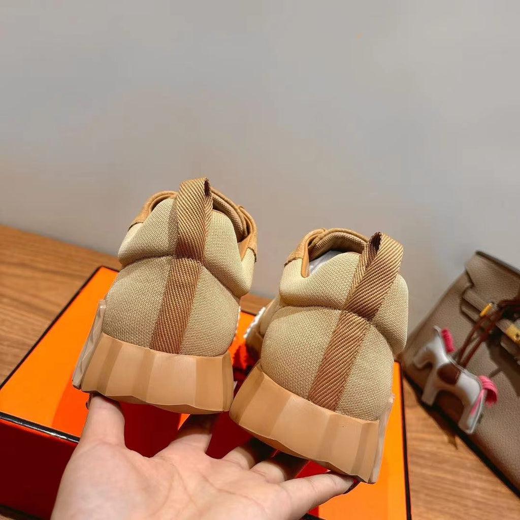 Hermes unisex beige sneakers, rear view with heel tabs and textured sole tread