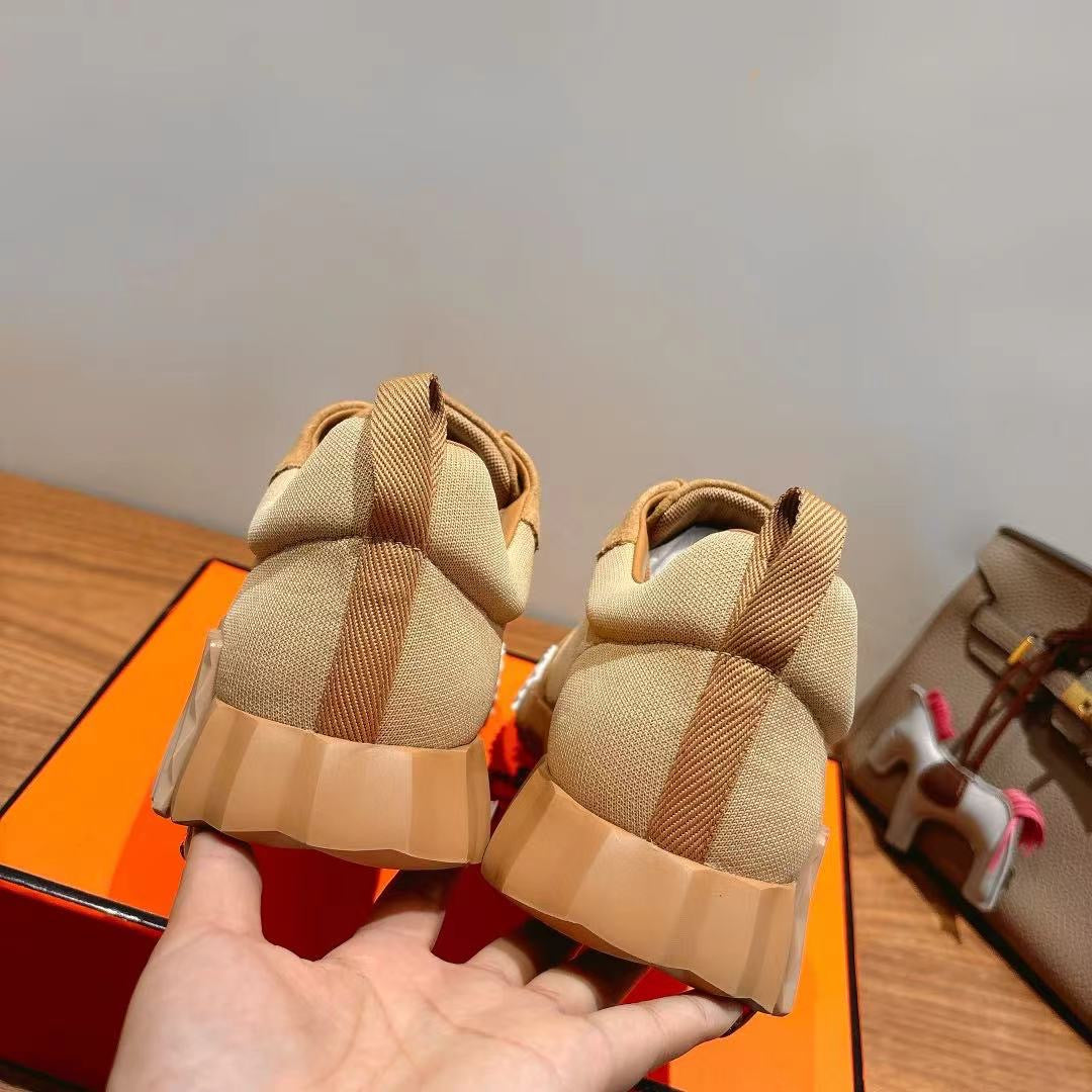 Hermes unisex beige sneakers, rear view with heel tabs and textured sole tread