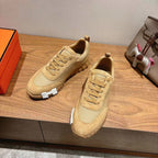 Hermes unisex beige lace-up sneakers, side view with contrast heel and stitching