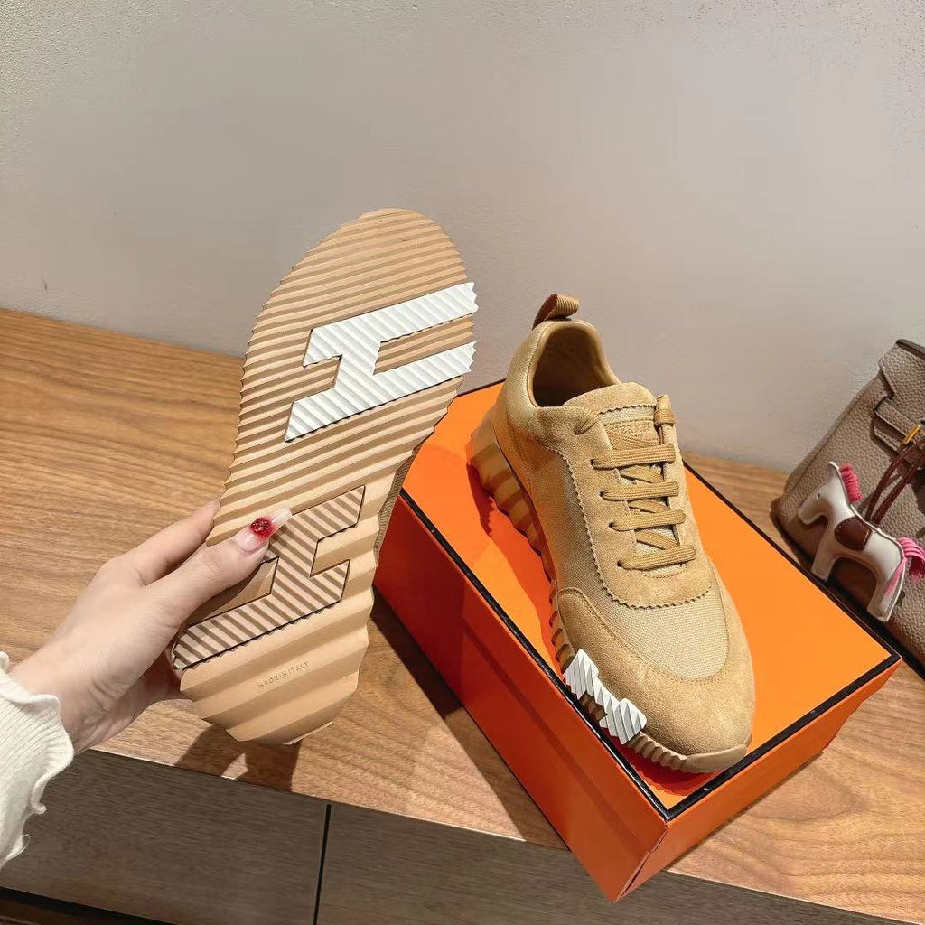 Hermes unisex beige sneakers, sole view with tread pattern and lace-up upper