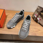 Gray suede lace-up sneakers, low-top profile, textured sidewall and white-striped sole